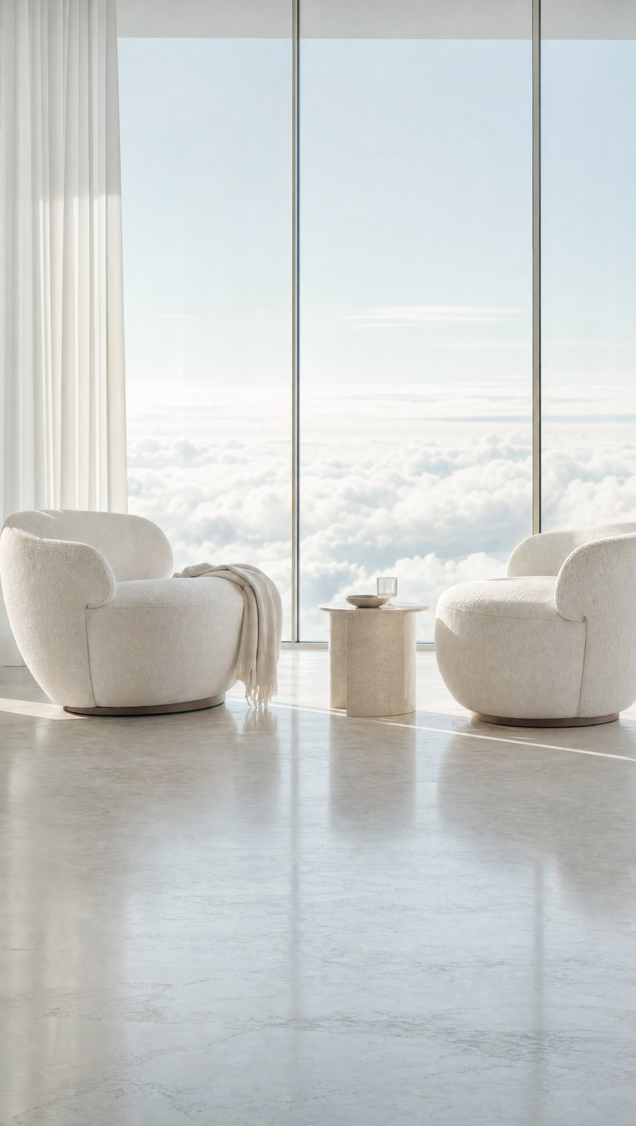 Two lounge chairs facing each other beside a cloudscape window